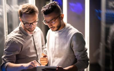 Two men looking at a tablet